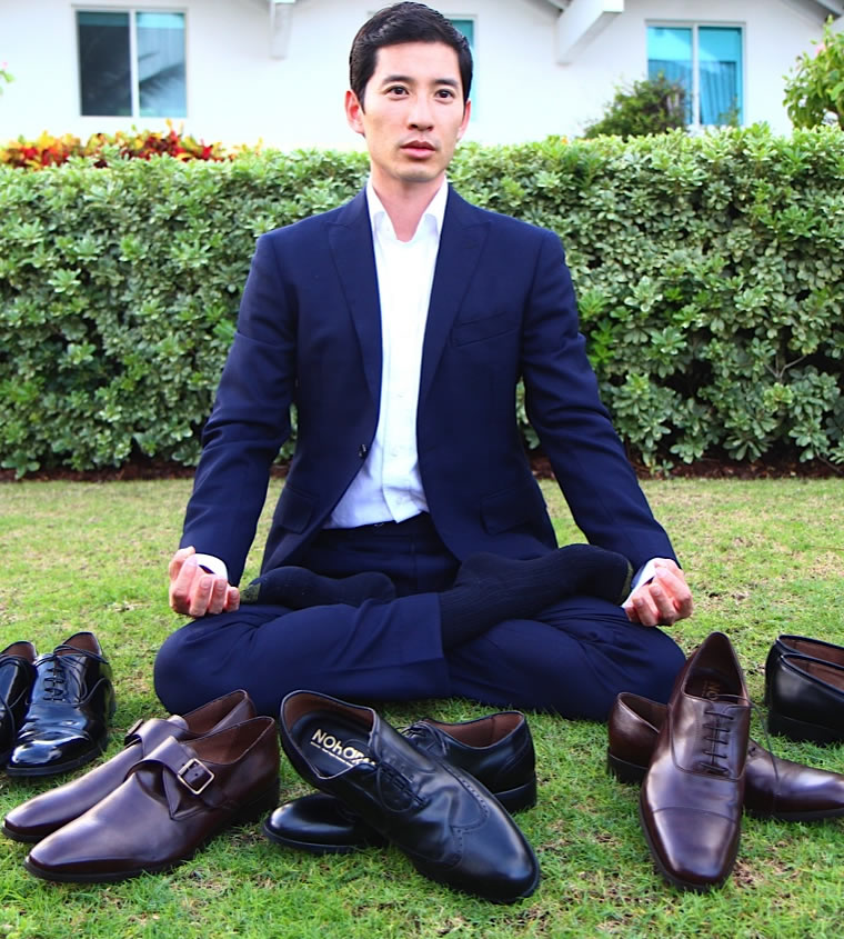Model in suit sitting with NOHARM® shoe collection